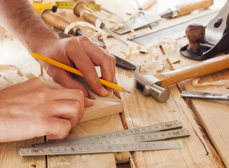 A person works on a construction project with tools