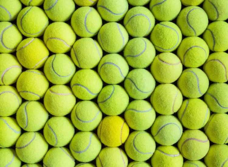 Tennis balls stacked together in rows