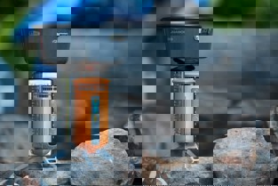 A small cooking pot hooked up to a biomass burner