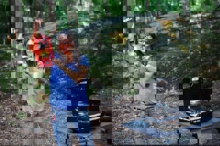 A person holding up a gas lantern