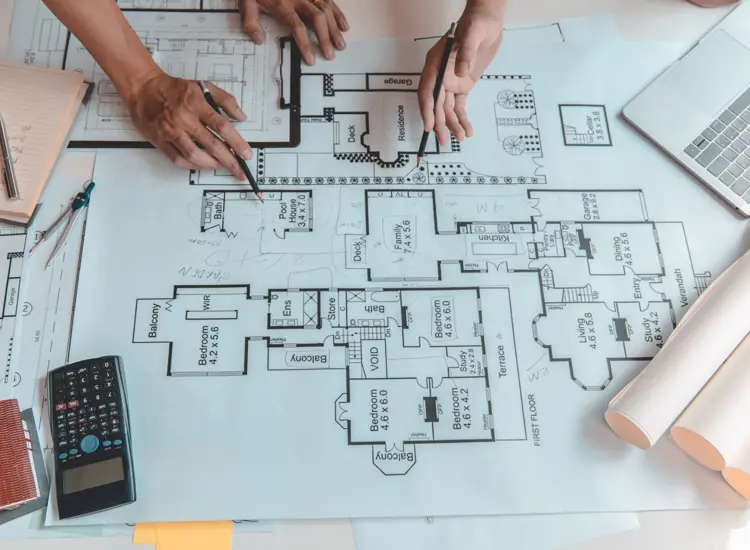 A person works on building plans